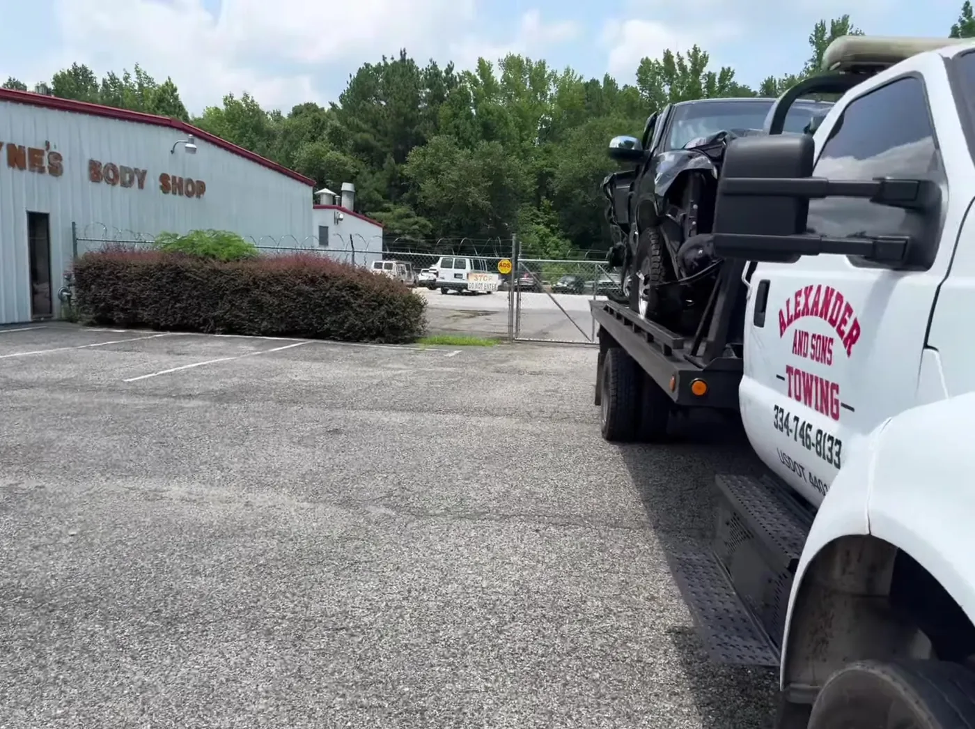 Wrecked pickup delivered to a body shop. Recovery and delivery handled by the same truck.