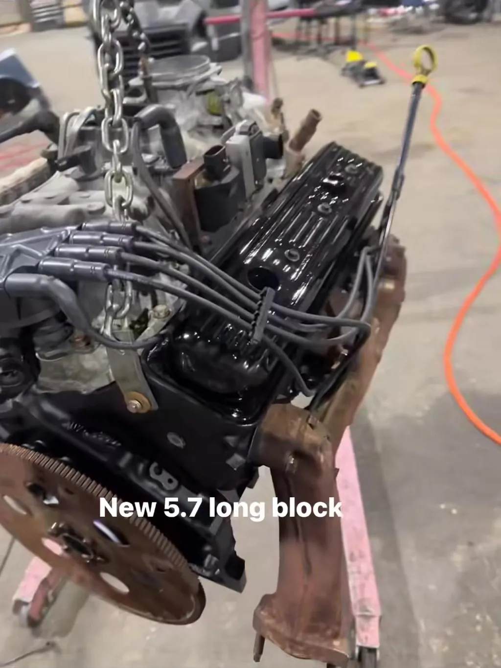 A new 5.7 long block on the hoist in the workshop