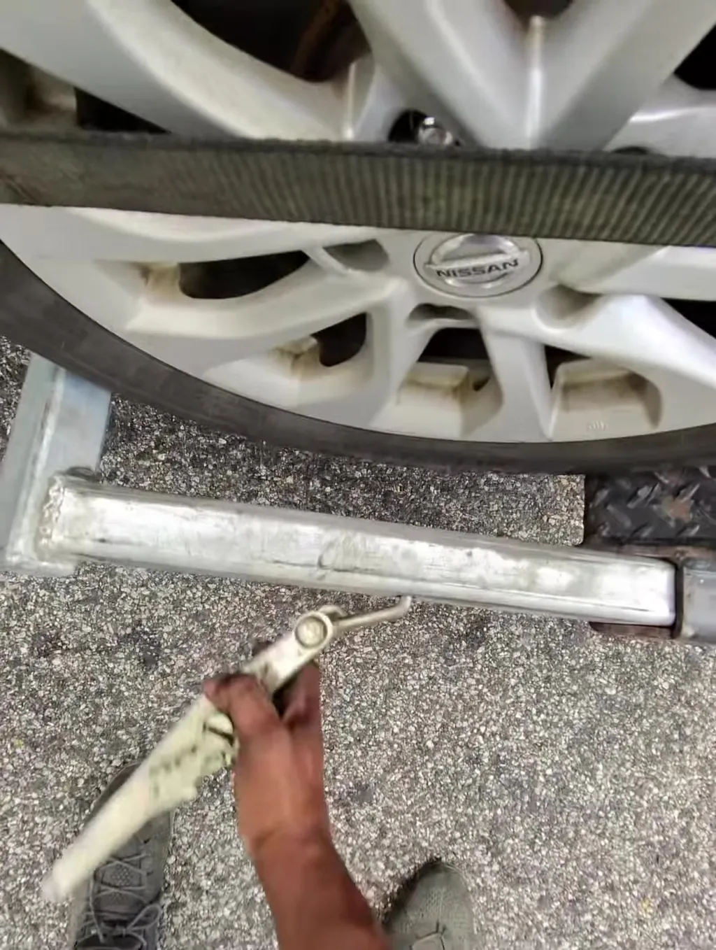 Wheel strap fed through the rim before the ratchet goes on. Straps go through the wheel, never over the paint.