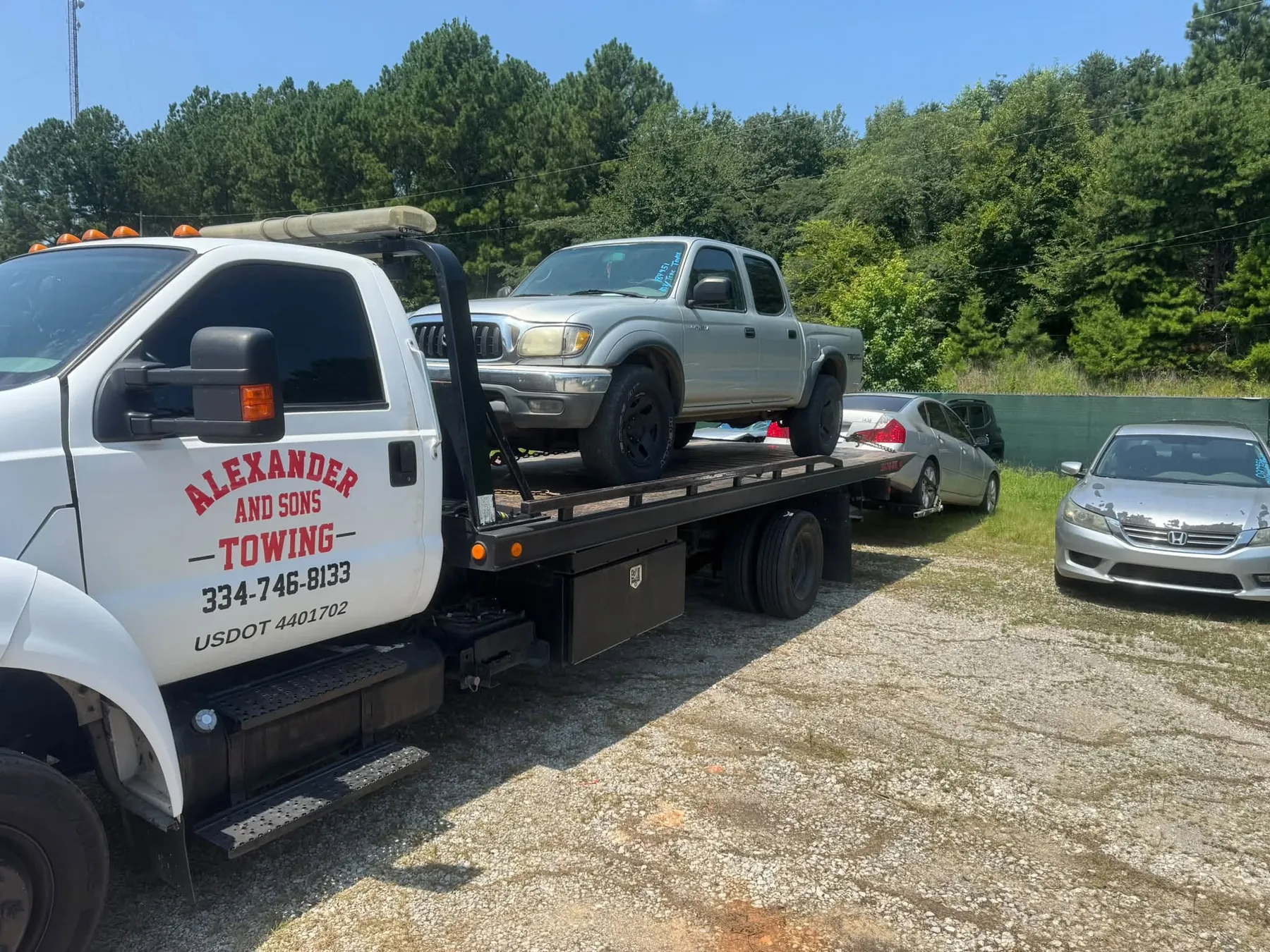 A Toyota Tacoma loaded on the rollback and ready to move.